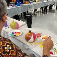 lady painting pumpkin